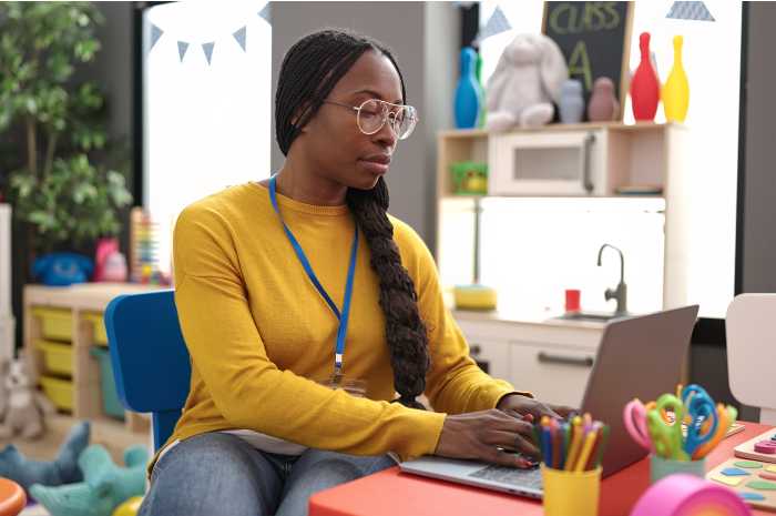 Female english teacher taking Google's Generative AI for Educators course on a laptop expressing satisfaction