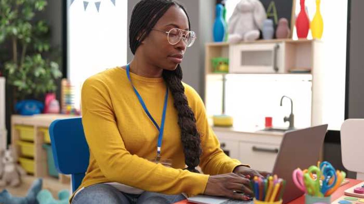 Female english teacher taking Google's Generative AI for Educators course on a laptop expressing satisfaction